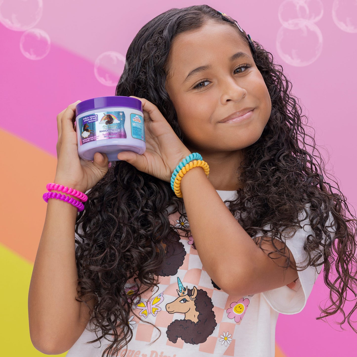 Afro Unicorn model holding a Swirls & Twirls Curl Cream product.
