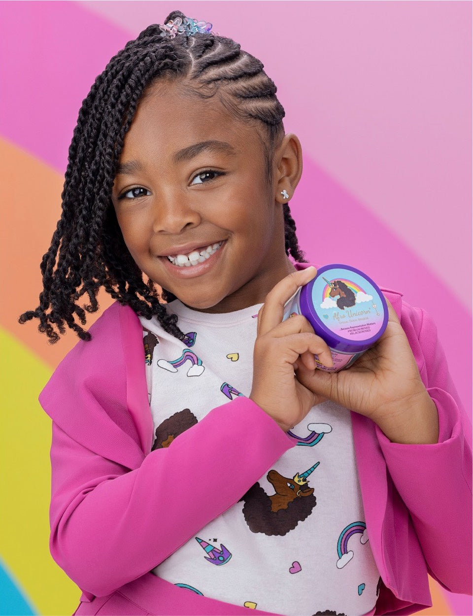 A model smiling while holding an Afro Unicorn jar.